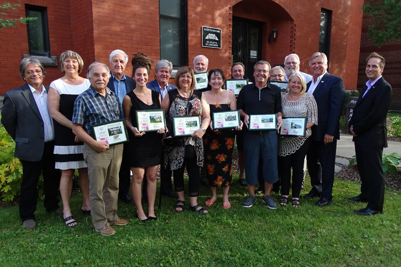 Les gagnants du Concours Oser vert posent fièrement avec leur plaque souvenir, entourés des membres du conseil municipal.