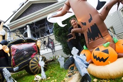 Jane Baal stands by her eleborate Halloween display in front of her Lake Street home Tuesday. Baal likes to get into the spirit and continues with the festivities at Christmas as well with elaborate Christmas decorations.