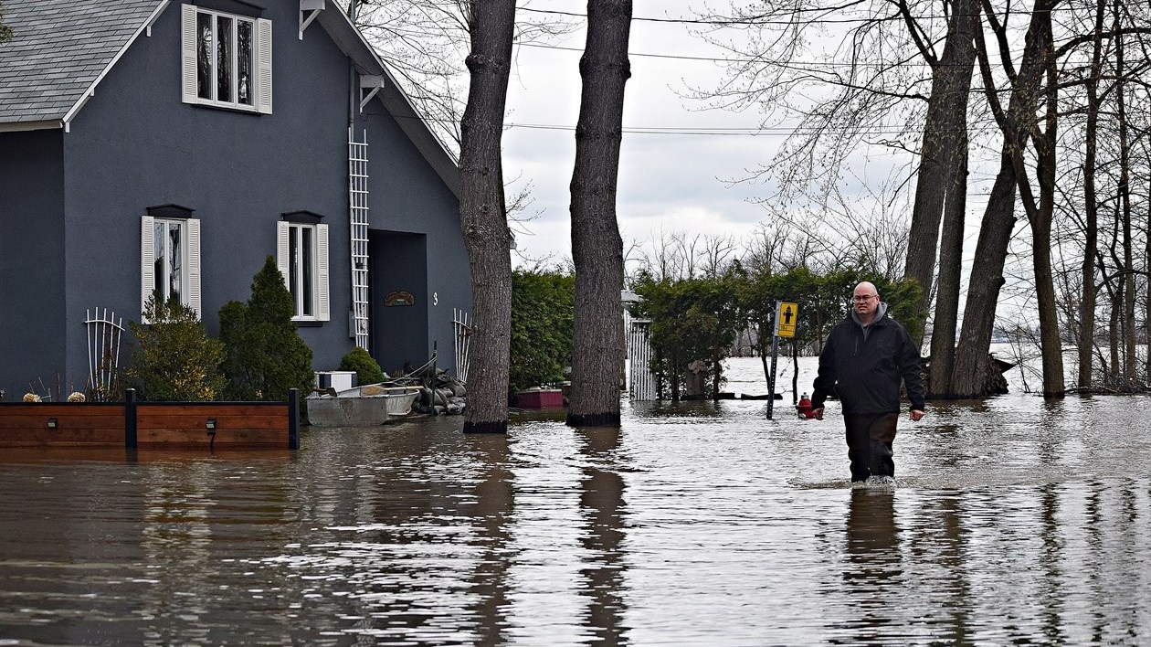 Terrasse-Vaudreuil Mayor Michel Bourdeau surveys the flood situation on 4th Avenue