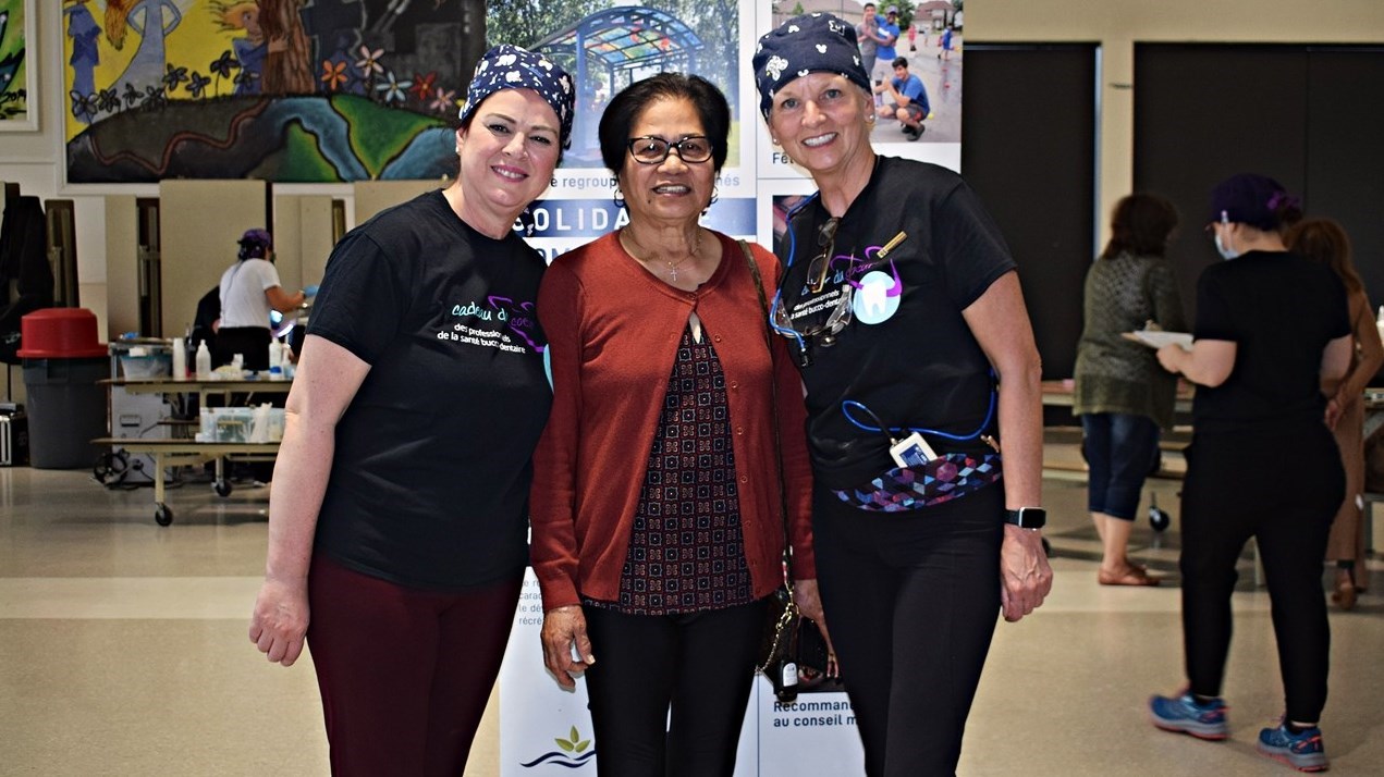 Concepcion Congso (centre), is flanked by dental hygienists Anila Hasko (left) and Catherine McConnell at the free dental cleaning clinic organized by the Pincourt Ville en Santé health committee on Saturday, May 27.