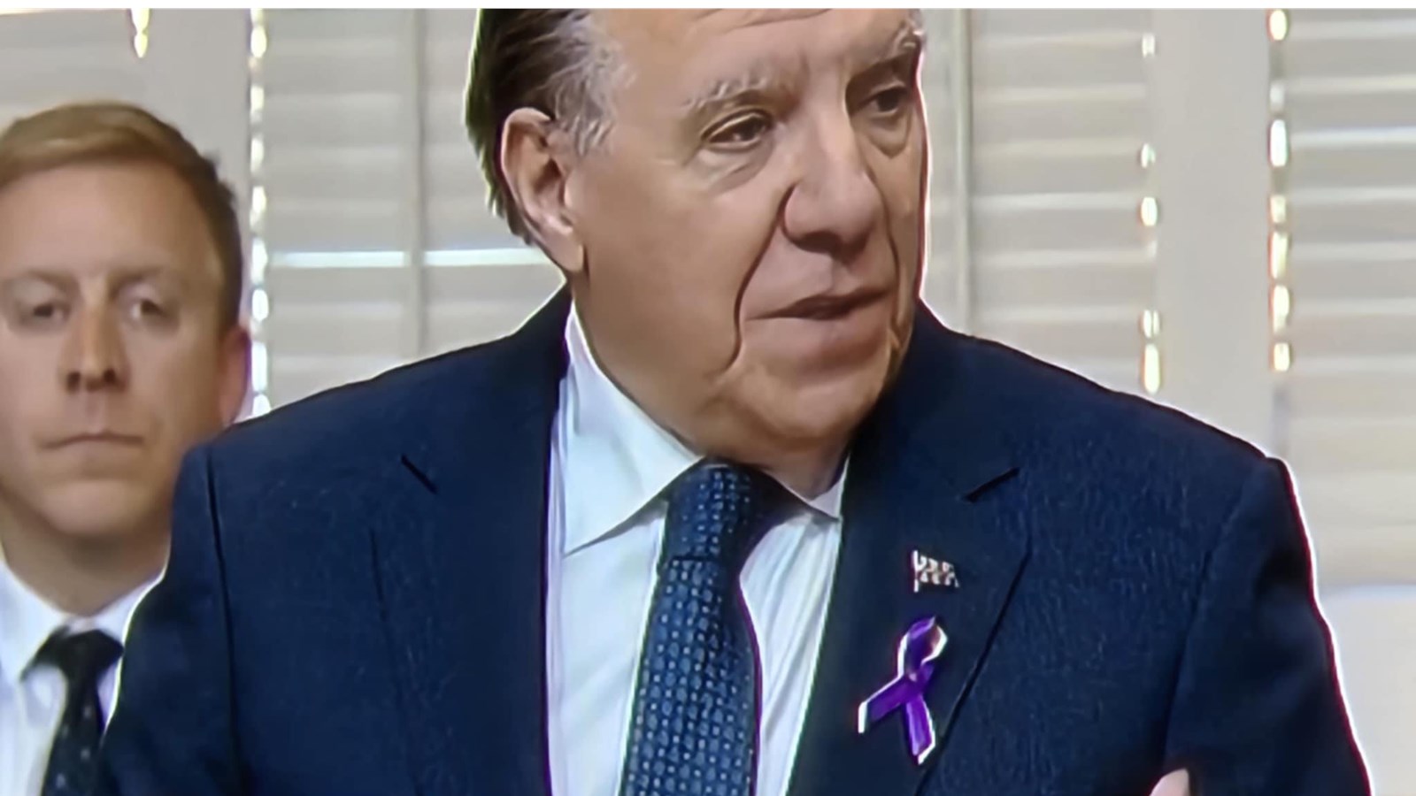 The Prime Minister wearing the yellow and purple TDL ribbon last week