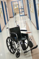 Empty wheelchair in a hospital corridor