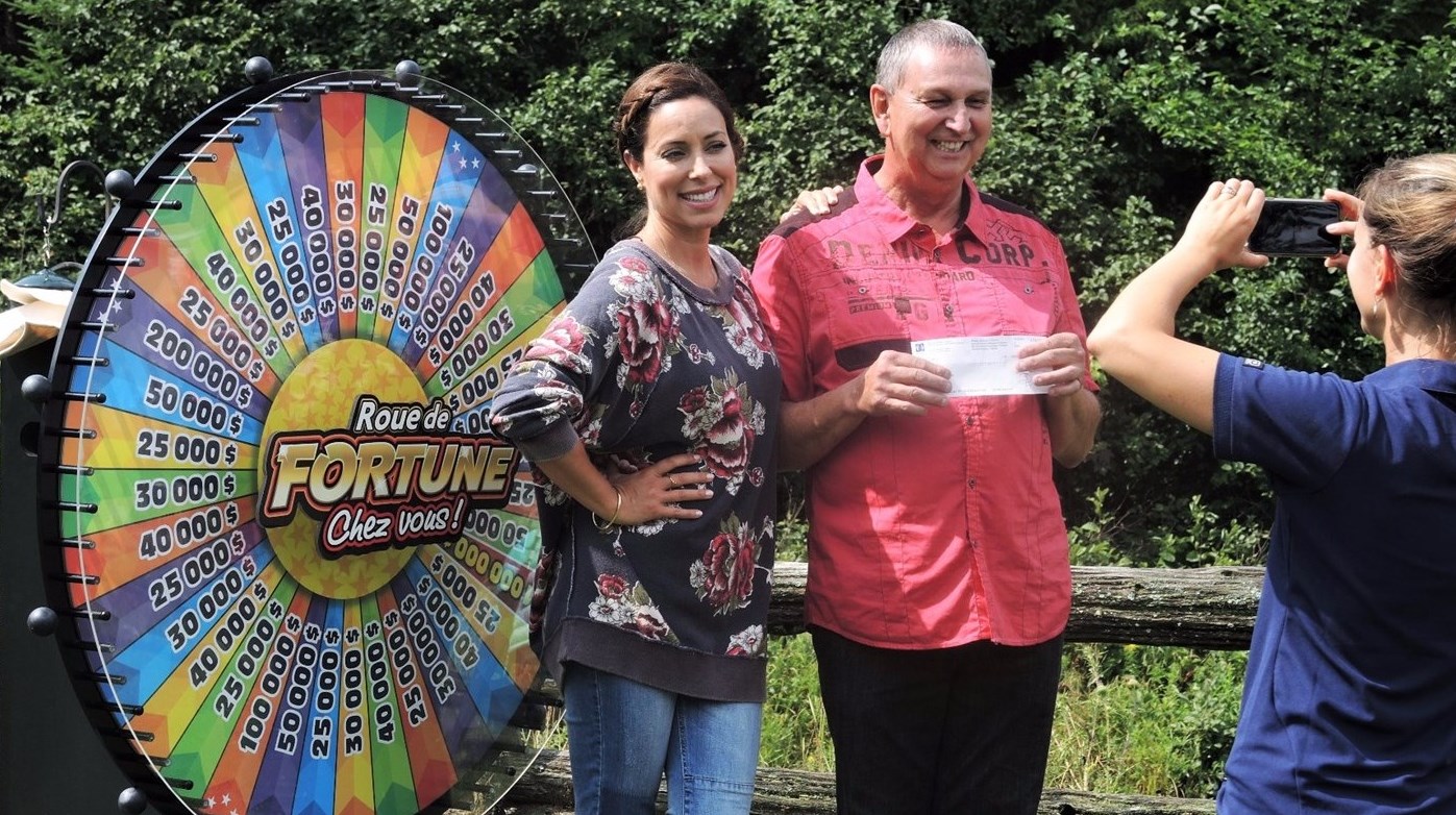 Cyrille Lavoie, résident de Beauceville, accompagné de l'animatrice de La Roue de fortune chez vous!, Anick Dumontet, lors du samedi 12 août 2017.