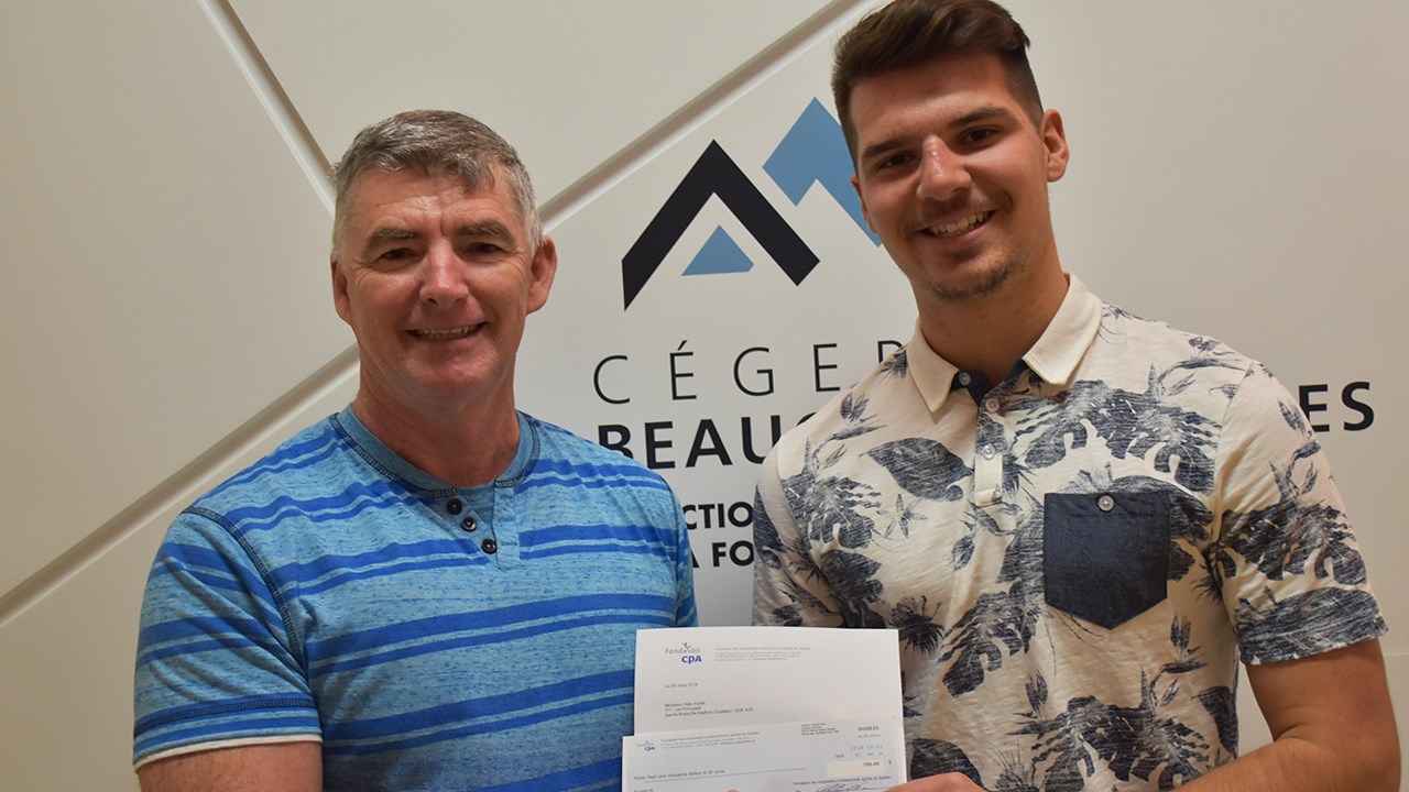 L'enseignant et comptable professionnel agréé, Hugues Drouin remettant la bourse à Alex Audet.