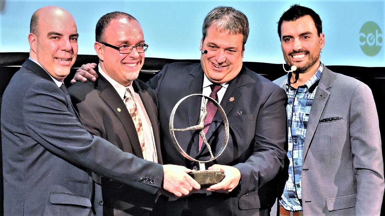 Le CEB a remis un cadeau souvenir à Martin Deschênes à la fin de sa conférence, soit une œuvre fabriquée spécialement pour lui par l’artiste sculpteur Paul Duval de Saint-Jean-de-la-Lande. Cette dernière s’intitule « Un grand pas ». De gauche à droite : Guy Bégin, président du comité organisateur de l'événement, Tony Turcotte, président du Conseil économique de Beauce, Martin Deschêne, conférencier du 25e Souper d'affaires de prestige du Conseil économique de Beauce, et David Hamel, animateur de la soirée.