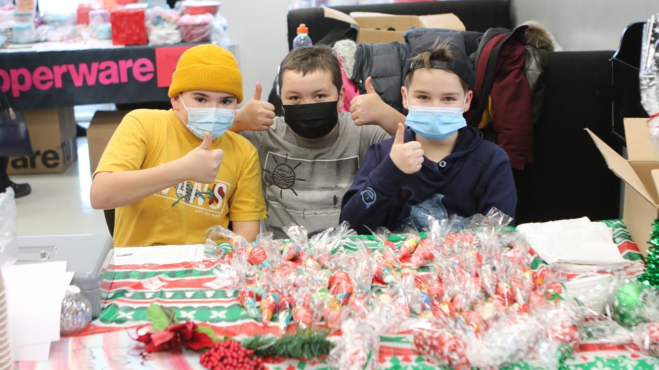 Trois élèves de l'école Arc-en-Ciel de Saint-Odilon lors du Marché de Noël de l'endroit.