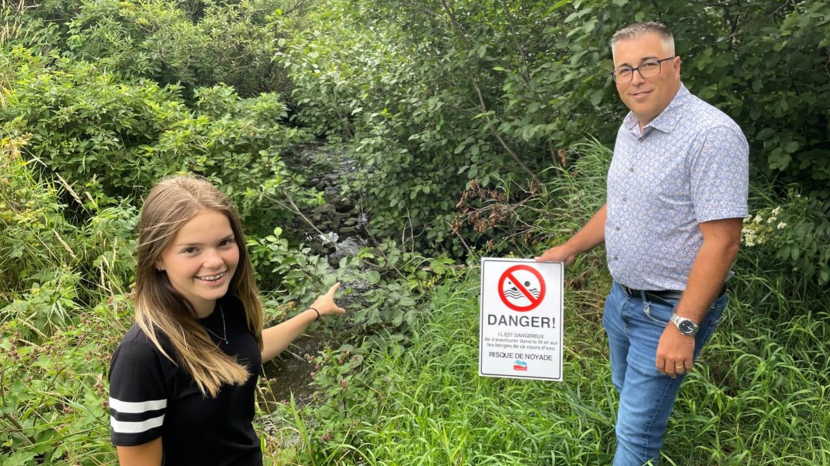 Ariel pointant les lieux de l'événement et Carl Marcoux présentant les nouveaux panneaux qui y seront installés