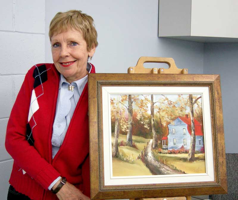 Ginette Leblond et la toile qu'elle a offerte lors du tirage.
